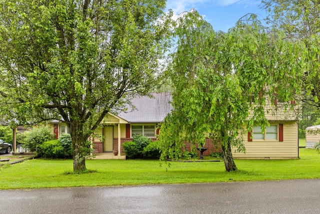 obstructed view of property featuring a front yard