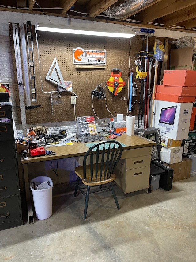 office area with a workshop area and concrete floors