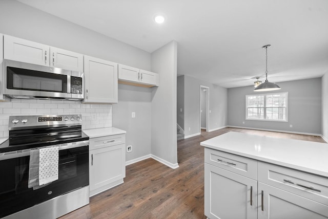 kitchen with stainless steel appliances, tasteful backsplash, light countertops, and white cabinetry