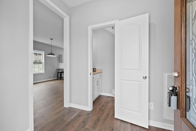 hall with baseboards and dark wood-style flooring