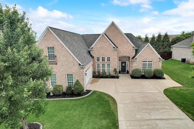 view of front of property with a front yard and central AC unit