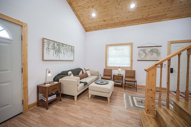 living room with baseboards, wooden ceiling, stairs, light wood-type flooring, and high vaulted ceiling