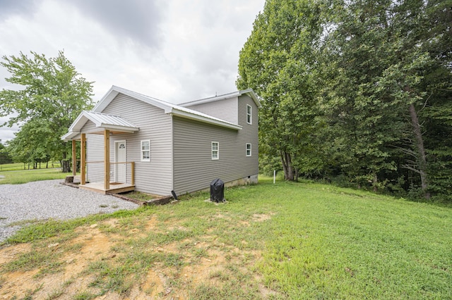 view of side of home featuring a lawn