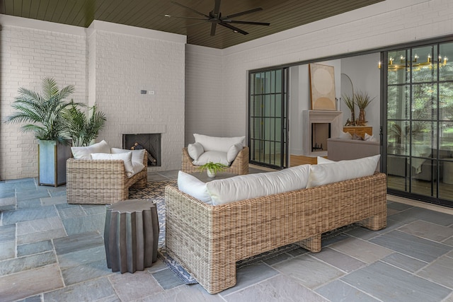 view of patio with an outdoor living space with a fireplace and ceiling fan