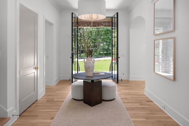 dining space featuring ornamental molding and light hardwood / wood-style floors