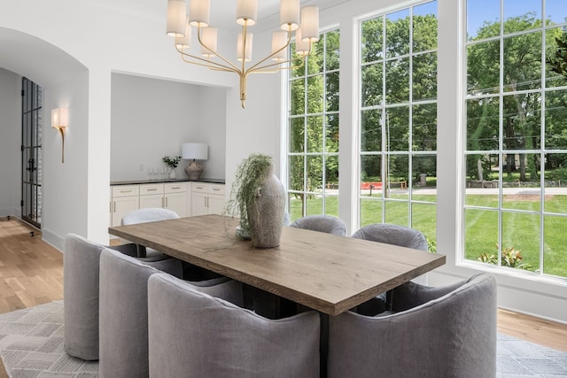 dining area featuring light hardwood / wood-style floors and an inviting chandelier