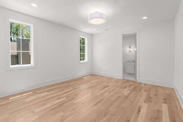 unfurnished room with light hardwood / wood-style floors