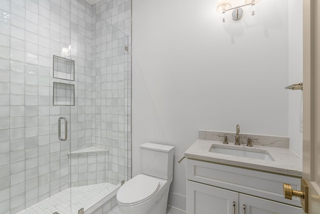 bathroom with walk in shower, vanity, and toilet