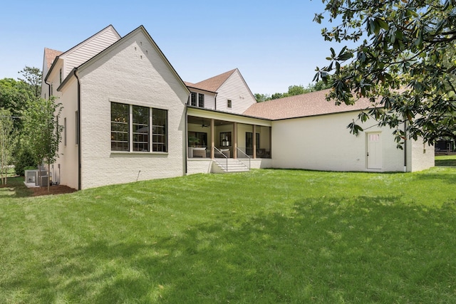 rear view of house featuring a yard