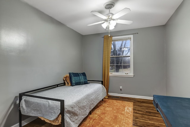 bedroom with ceiling fan and dark wood-type flooring