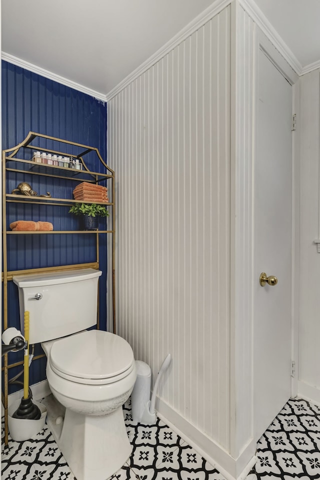 bathroom with ornamental molding and toilet