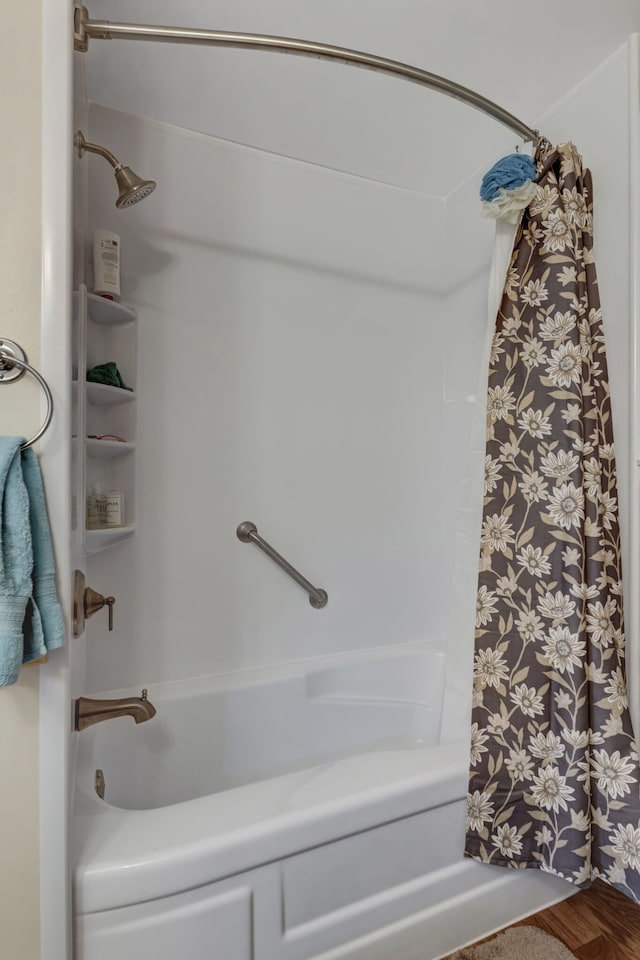 bathroom with shower / bathtub combination with curtain and wood-type flooring