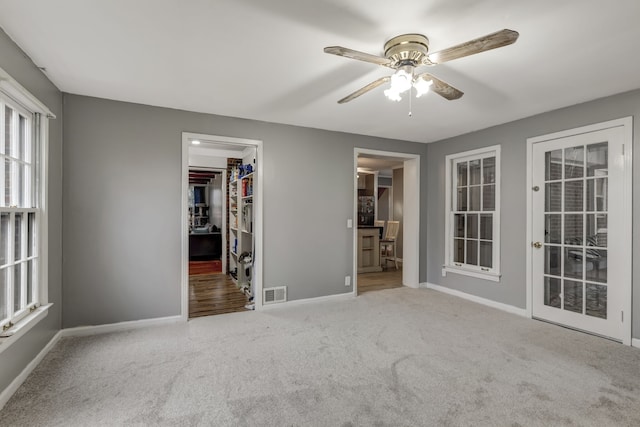 interior space with ceiling fan