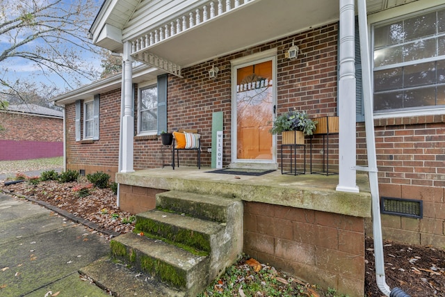 view of exterior entry featuring a porch