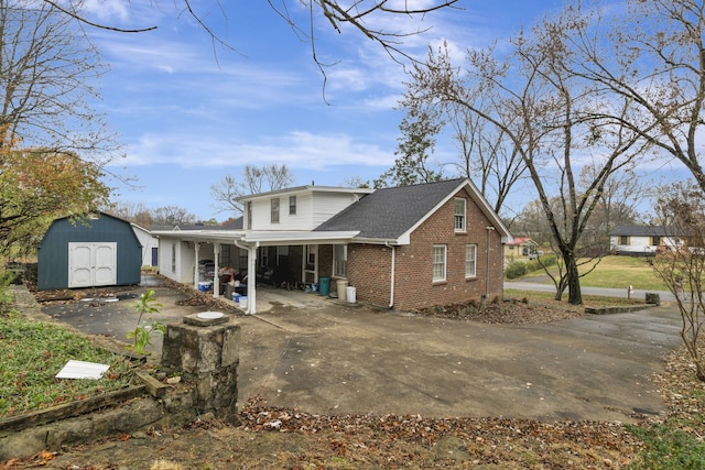 back of property featuring a storage shed