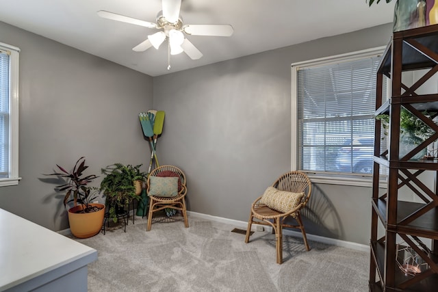 living area featuring ceiling fan and carpet floors