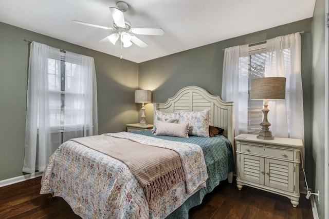 bedroom with dark wood-type flooring, ceiling fan, and multiple windows