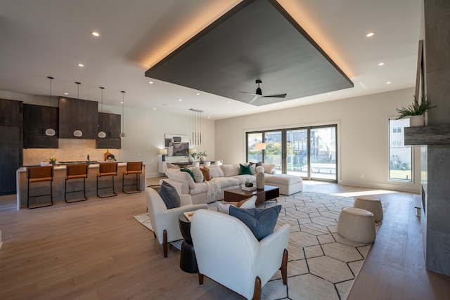 living room with ceiling fan and hardwood / wood-style flooring