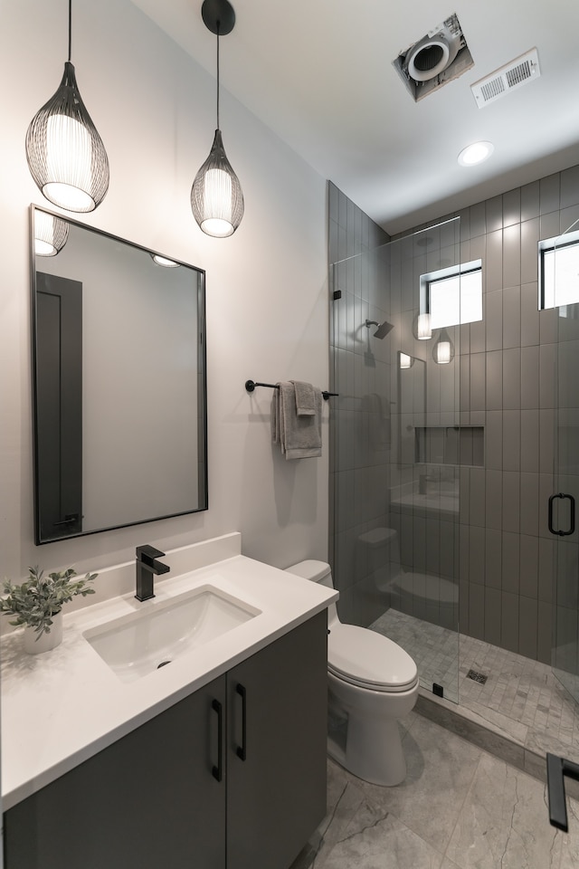 bathroom featuring walk in shower, tile flooring, toilet, and vanity