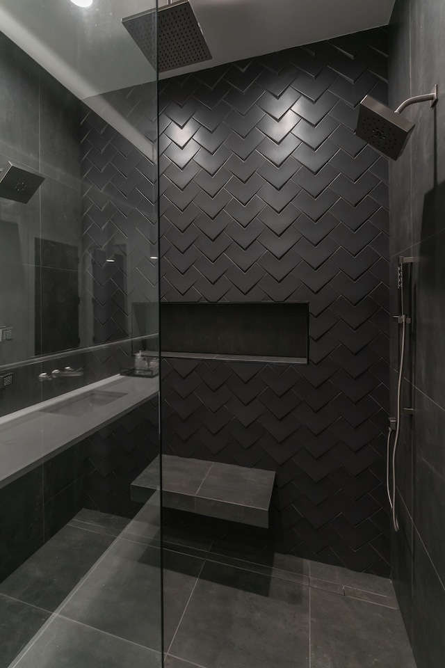 bathroom featuring tiled shower, tile flooring, and tile walls