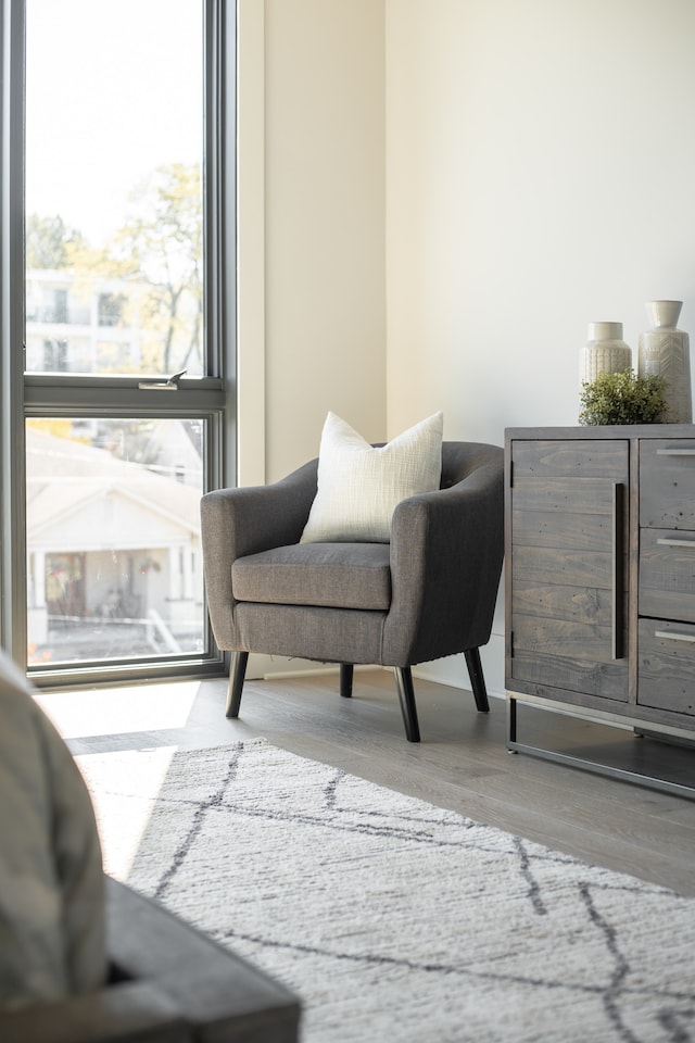 living area featuring floor to ceiling windows and hardwood / wood-style floors