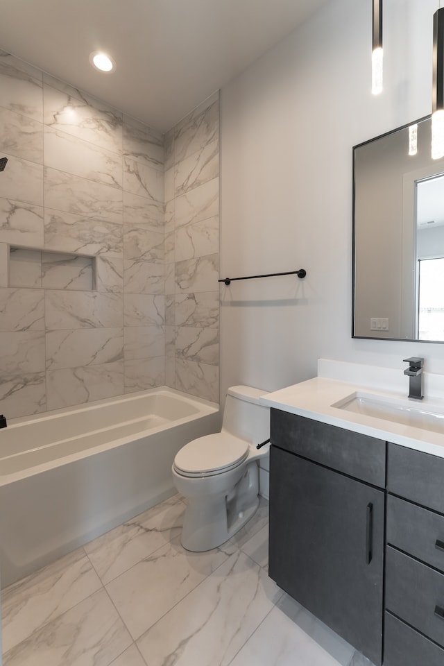 full bathroom with tile flooring, vanity, toilet, and tiled shower / bath combo