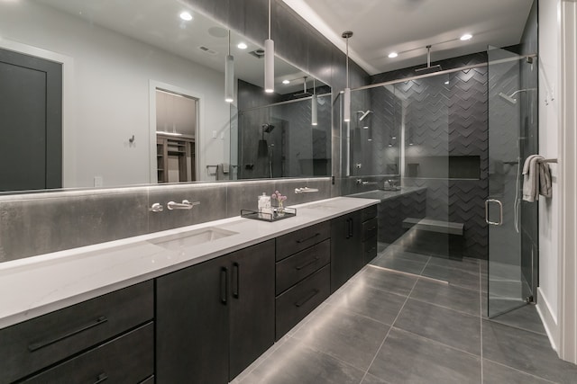 bathroom with backsplash, double vanity, tile flooring, and a shower with door