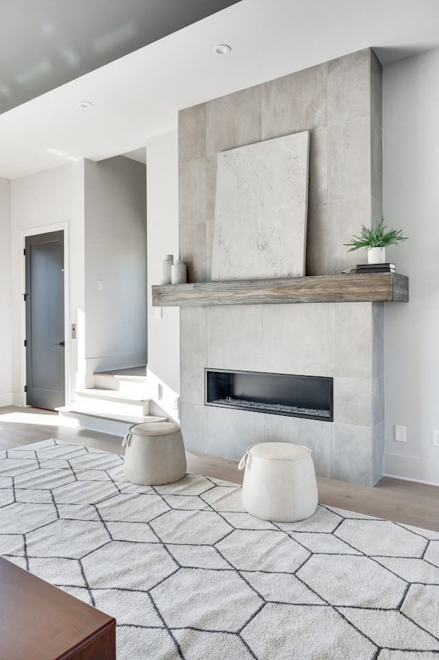 interior space featuring a tile fireplace and hardwood / wood-style floors