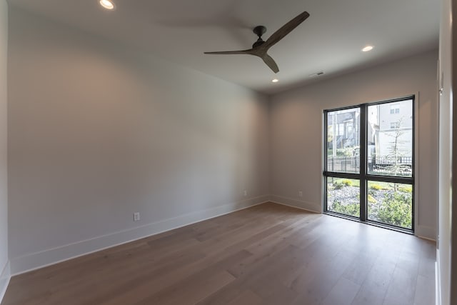 unfurnished room featuring ceiling fan and hardwood / wood-style flooring