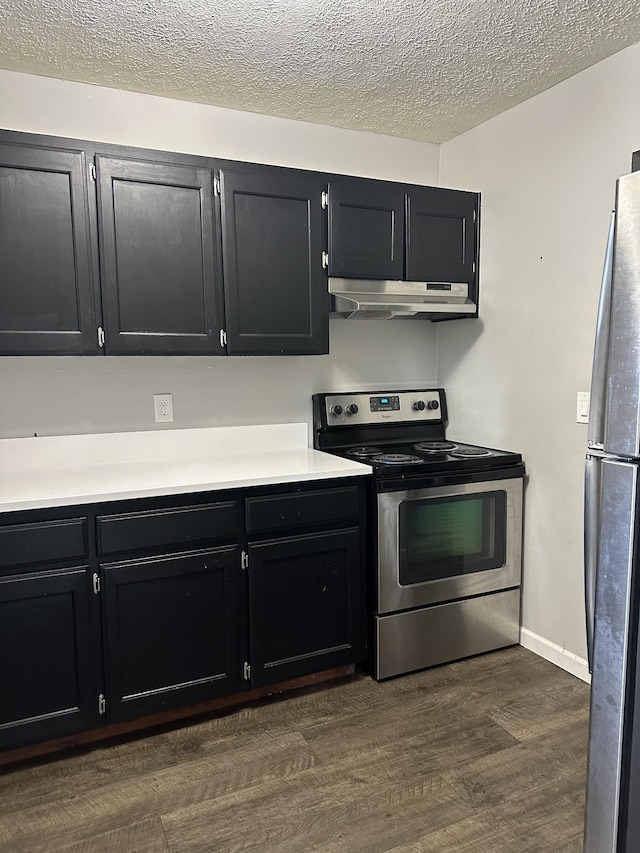 kitchen with stainless steel appliances, dark hardwood / wood-style floors, and a textured ceiling