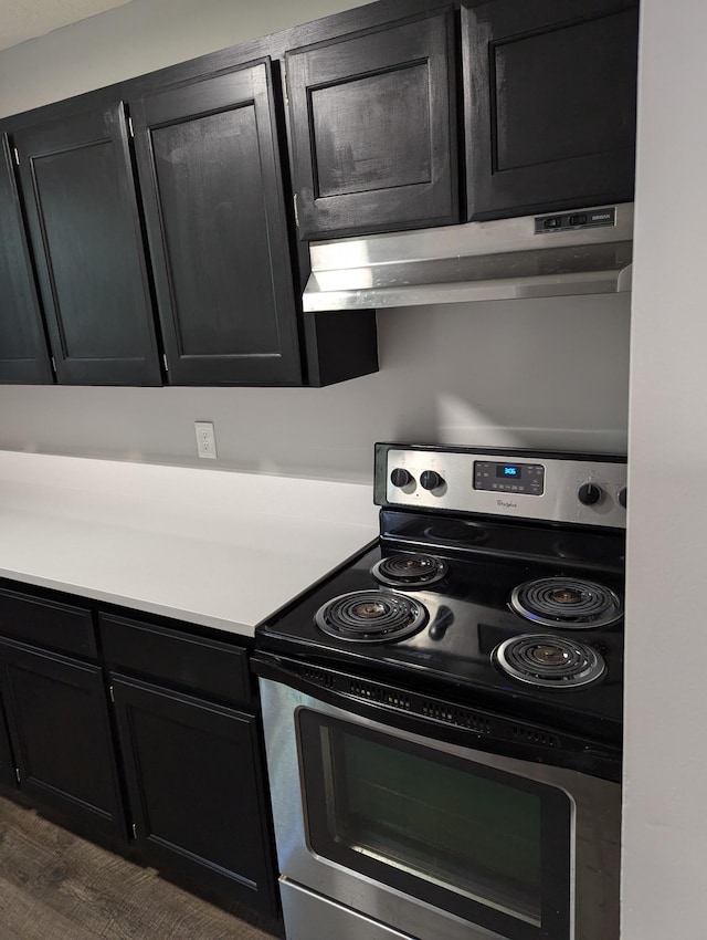 kitchen with stainless steel electric range and dark wood-type flooring