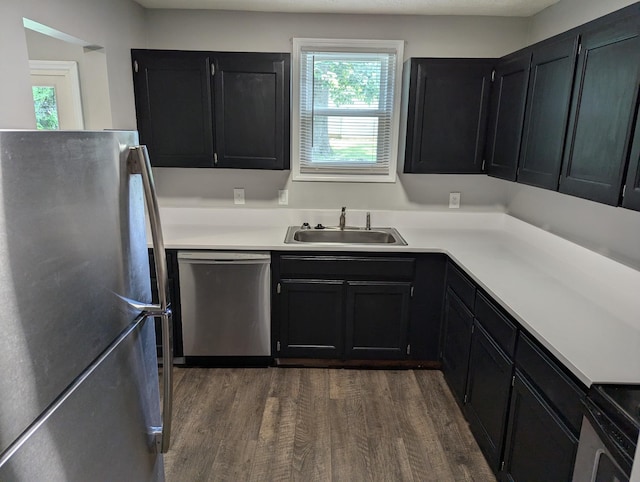 kitchen with sink, dark hardwood / wood-style floors, and appliances with stainless steel finishes