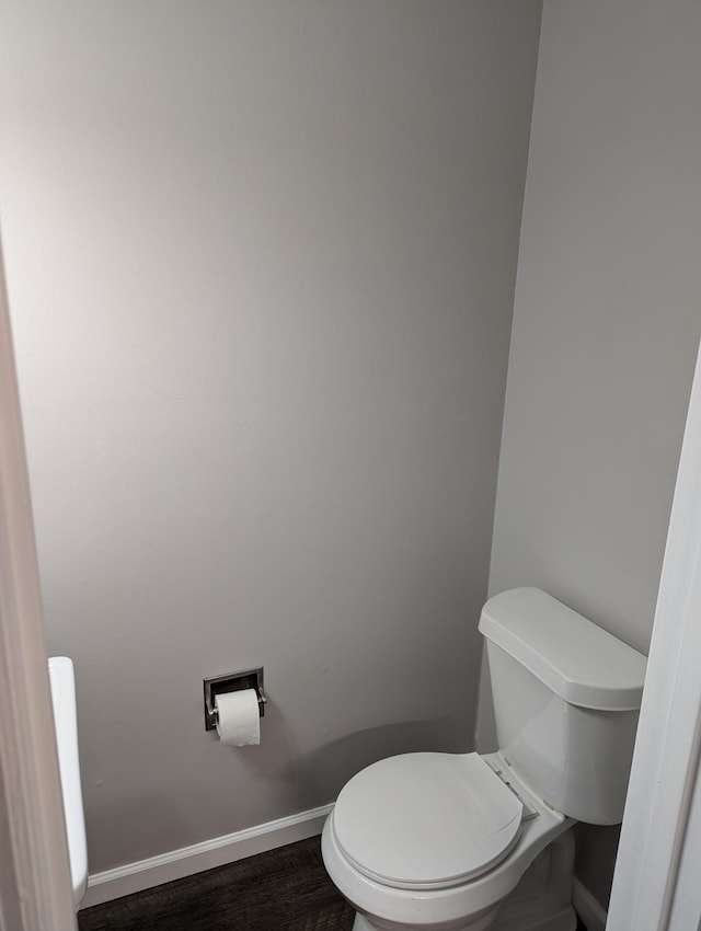 bathroom with wood-type flooring and toilet