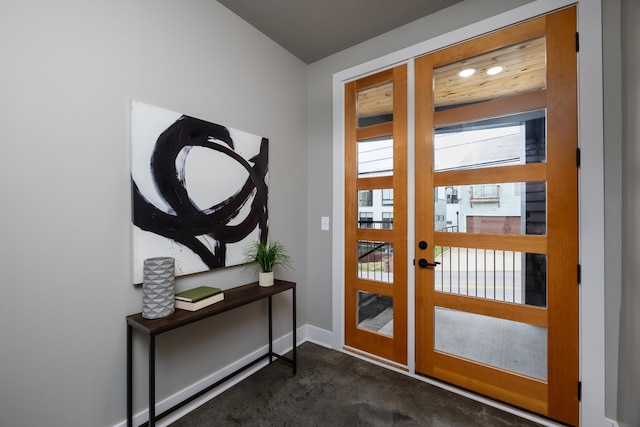 entryway featuring dark colored carpet and french doors