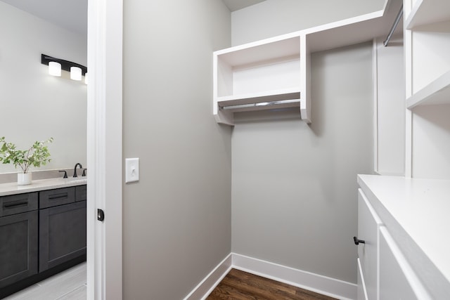 laundry area featuring sink and light wood-type flooring