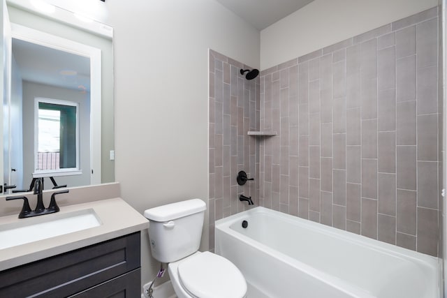 full bathroom featuring tiled shower / bath, toilet, and vanity