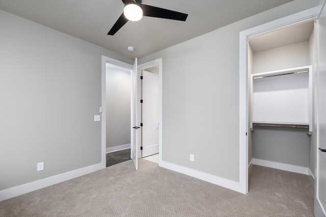 unfurnished bedroom with a closet, carpet floors, and ceiling fan