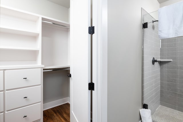 bathroom featuring tiled shower and hardwood / wood-style floors