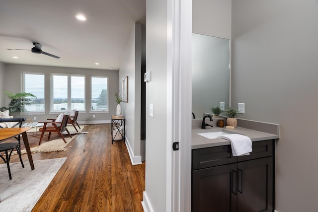 bathroom featuring hardwood / wood-style floors, sink, and ceiling fan