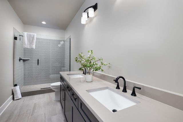 bathroom featuring walk in shower, tile flooring, double sink vanity, and toilet