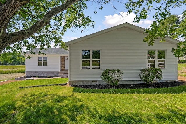 rear view of property featuring a yard