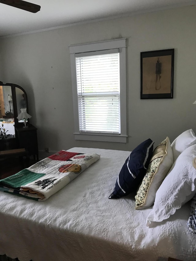 bedroom featuring ornamental molding and ceiling fan