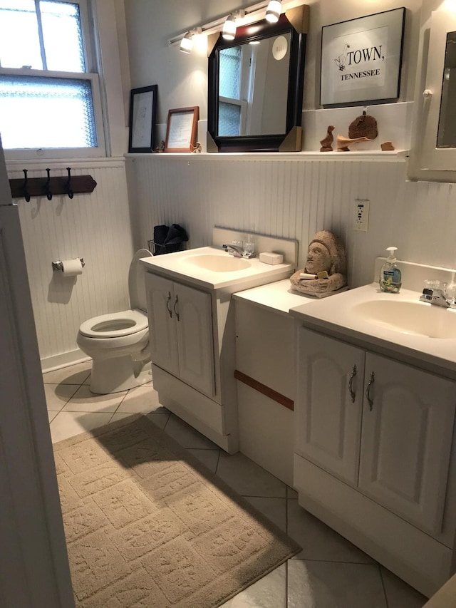 bathroom featuring tile floors, toilet, and vanity