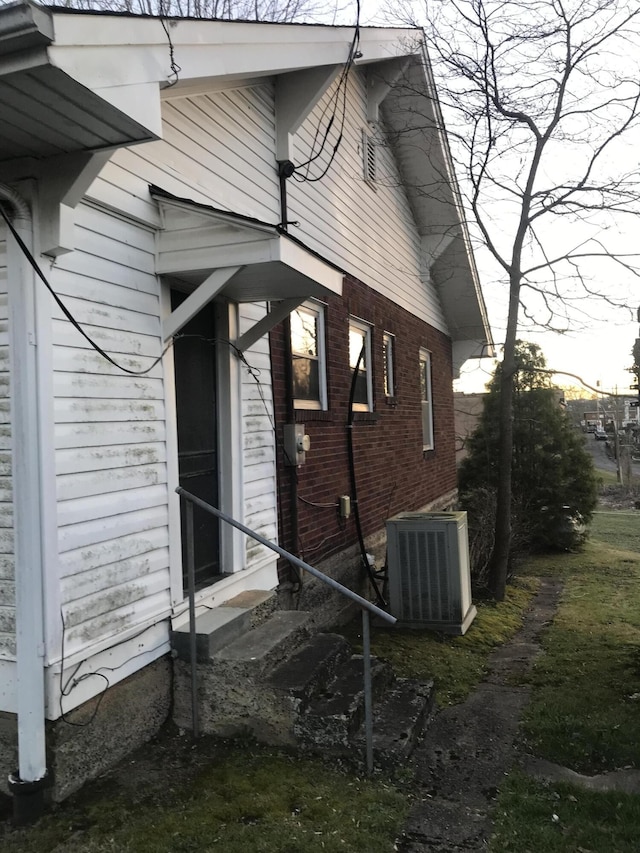 view of side of property with central air condition unit