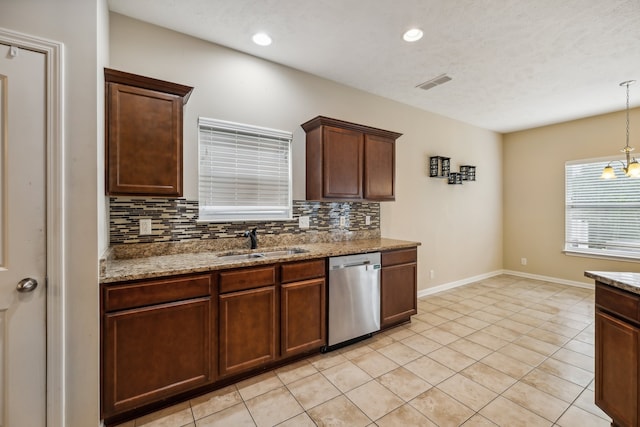 kitchen with stone countertops, sink, tasteful backsplash, and stainless steel dishwasher