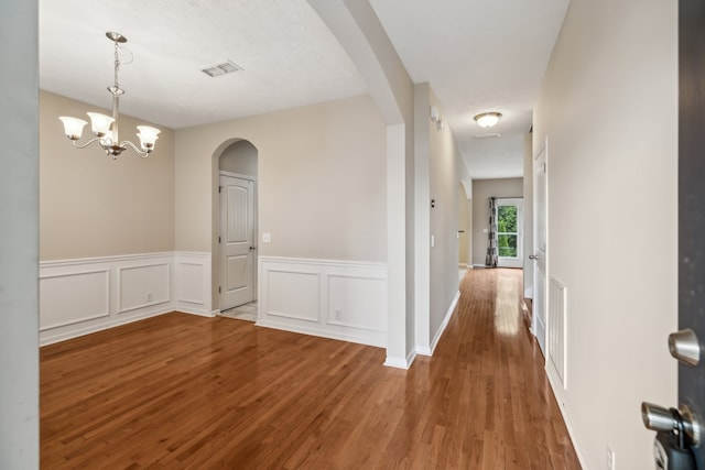 interior space featuring a chandelier and wood-type flooring