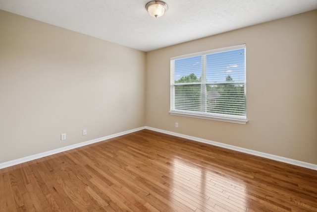 spare room featuring hardwood / wood-style flooring