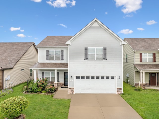 view of front of property with a garage and a front yard