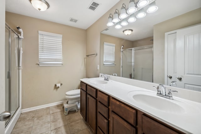 bathroom featuring walk in shower, tile patterned floors, vanity, and toilet