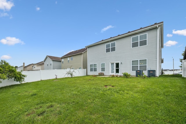 rear view of property with a lawn